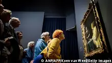 Visitors look at the painting Mistress and Maid during the opening of the Johannes Vermeer exhibition in the Rijksmuseum in Amsterdam on February 9, 2023. - Guests from all over the Netherlands who have a link with the name Vermeer have been invited to the opening. The exhibition contains 28 of the 37 works made by Johannes Vermeer. - Netherlands OUT (Photo by Koen van Weel / ANP / AFP) / Netherlands OUT (Photo by KOEN VAN WEEL/ANP/AFP via Getty Images)