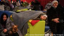 TOPSHOT - Refugees from Ukraine rest in the main train station of Krakow on March 6, 2022, as they wait to be relocated to other temporary accomodations in Poland or abroad. - The number of people fleeing Russia's invasion of Ukraine has topped 1.5 million, making it Europe's fastest growing refugee crisis since World War II, the United Nations said on March 6, 2022. More than 1.5 million refugees from Ukraine have crossed into neighbouring countries in 10 days - the fastest growing refugee crisis in Europe since World War II, it said in a statement on Twitter. (Photo by Louisa GOULIAMAKI / AFP) (Photo by LOUISA GOULIAMAKI/AFP via Getty Images)