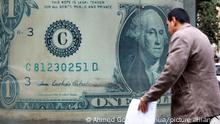 (221226) -- CAIRO, Dec. 26, 2022 (Xinhua) -- A man passes a foreign exchange office in Cairo, Egypt, Dec. 25, 2022. In the past year, the Egyptian government has been striving to curb soaring inflation caused by rising food and energy prices as a result of the Russia-Ukraine conflict and lingering COVID-19 pandemic. TO GO WITH Yearender: Egypt strives to maintain economic stability amid high inflation, currency devaluation (Xinhua/Ahmed Gomaa)