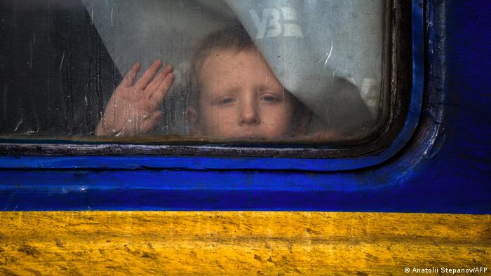 A young boy looks out the window of an evacuation train in the city of Pokrowsk in the Donetsk region