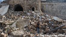 A boy stands on rubble in the aftermath of an earthquake near Aleppo's ancient citadel, in the old city of Aleppo, Syria February 7, 2023. REUTERS/Firas Makdesi 