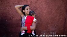 In this July 25, 2019 photo, Nicol Ramirez, 15, holding her baby girl, waits outside a clinic to get a hormonal implant to prevent future pregnancies in the Caucaguita neighborhood on the outskirts of Caracas, Venezuela. Ramírez and her sister were among the lucky few to get the last of the implants after their mom paid for a pregnancy test and they were able to prove they were not pregnant. (AP Photo/Ariana Cubillos)