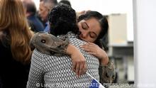 15.2.2023, Nicaragua, Maria Jose Aragon holds a Nicaraguan flag as she hugs Maria Jose Martinez, both recently released political prisoner from Nicaragua, during a news conference at the office of Miami-Dade County Mayor Daniella Levine-Cava, Wednesday, Feb. 15, 2023, in Miami. Nicaraguan President Daniel Ortega recently sent 222 political leaders, priests, students, activists and other dissidents to the United States, whose release was long demanded by the international community. (AP Photo/Lynne Sladky)