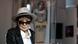 Yoko Ono, woman with a hat peers over her sunglasses Yoko Ono, woman with a hat peers over her sunglasses
