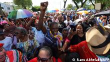 People protest against government economic policies in Paramaribo, on February 17, 2023. - Hundreds of people protested in Suriname Friday against rising living costs, clashing with security forces in the capital Paramaribo and looting city center shops, AFP observed. (Photo by Ranu Abhelakh / AFP)