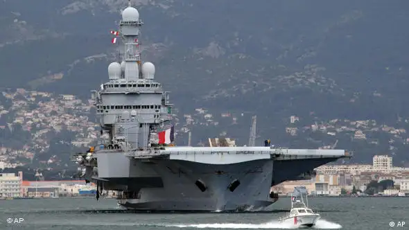 France's nuclear-powered aircraft carrier Charles de Gaulle leaves its home port of Toulon, southern France, Sunday, March 20, to the Mediterranean sea. Top officials from the United States, Europe and the Arab world have launched immediate military action to protect civilians as Libyan leader Moammar Gadhafi's forces attacked the heart of the country's rebel uprising . (AP Photo/Claude Paris)