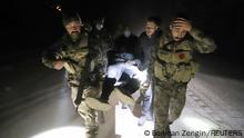 Members of Turkish police special forces carry a wounded man after an earthquake in Antakya, Hatay province, Turkey February 20, 2023. REUTERS/Berkcan Zengin NO RESALES. NO ARCHIVES.
