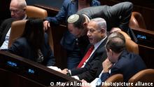 Israel's Prime Minister Benjamin Netanyahu, center right, confers with lawmakers as they convene in Israel's parliament, the Knesset, for a vote on a contentious plan to overhaul the country's legal system, in Jerusalem, Monday, Feb. 20, 2023. (AP Photo/Maya Alleruzzo, Pool)