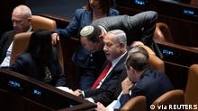 Israel's Prime Minister Benjamin Netanyahu, confers with lawmakers, as they convene in Israel's parliament, the Knesset, for a vote on a contentious plan to overhaul the country's legal system, in Jerusalem, February 20, 2023. Maya Alleruzzo/Pool via REUTERS