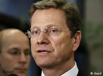 German Foreign Minister Guido Westerwelle speaks with the media prior to an EU foreign ministers round table meeting at the European Council building in Brussels, Monday, March 21, 2011. The European Union's top foreign policy official brushed aside concerns Monday that the coalition supporting military action against Libyan leader Col. Moammar Gadhafi is already starting to fracture, saying the head of the Arab League was misquoted as criticizing the operation. (AP Photo/Elisa Day)