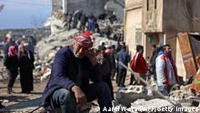 TOPSHOT - A Syrian man cries as he sits on the rubble of a collapsed building in the rebel-held town of Jindayris on February 7, 2023, following a deadly quake. - The Syrian Red Crescent appealed to Western countries to lift sanctions and provide aid after a powerful earthquake has killed more than 1,600 people across the war-torn country. The 7.8-magnitude quake early the previous day, which has also killed thousands in neighbouring Turkey, led to widespread destruction in both regime-controlled and rebel-held parts of Syria. (Photo by AAREF WATAD / AFP) (Photo by AAREF WATAD/AFP via Getty Images)