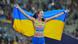 Yaroslava Mahuchikh holding up the Ukrainian flag behind her Yaroslava Mahuchikh holding up the Ukrainian flag behind her