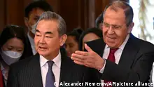 Russian Foreign Minister Sergey Lavrov, right, welcomes the Chinese Communist Party's foreign policy chief Wang Yi for their talks in Moscow, Russia, Wednesday, Feb. 22, 2023. (Alexander Nemenov/Pool Photo via AP)