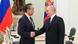 Vladimir Putin and Wang Yi shake hands Vladimir Putin and Wang Yi shake hands
