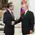 Vladimir Putin and Wang Yi shaking hands