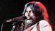 George Harrison singing into a microphone George Harrison singing into a microphone