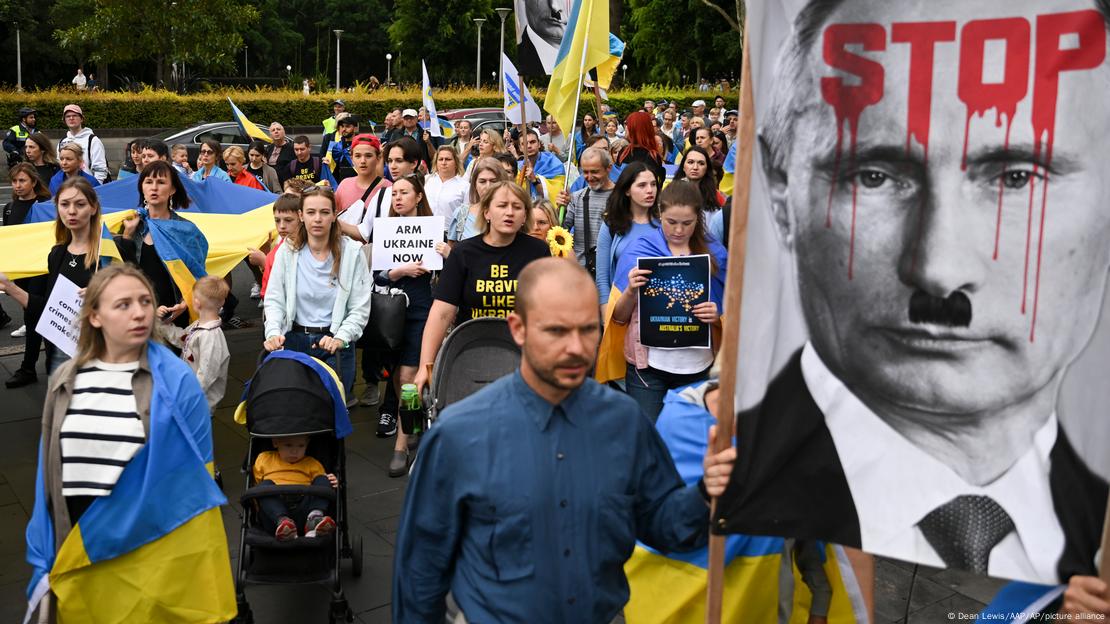 Members of Sydney's Ukraine community hold a candle light vigil to commemorate the one-year anniversary of Russia's invasion of Ukraine, in front of St. Mary's Cathedral in Sydney, Thursday, Feb. 23, 2023.