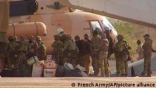 This undated photograph handed out by French military shows Russian mercenaries boarding a helicopter in northern Mali. Russia has engaged in under-the-radar military operations in at least half a dozen countries in Africa in the last five years using a shadowy mercenary force analysts say is loyal to President Vladimir Putin. The analysts say the Wagner Group of mercenaries is also key to Putin's ambitions to re-impose Russian influence on a global scale. (French Army via AP)