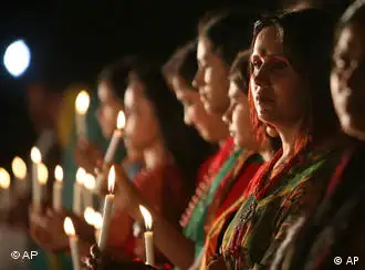 Bangladeshis participate in a candle light vigil at the Liberation War Museum to mark the killing of thousands of unarmed Bengalis by the then West Pakistani forces in 1971