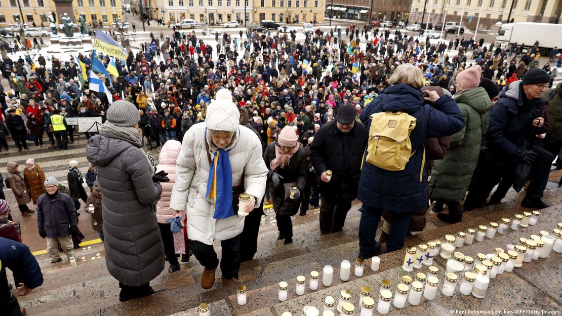 People place candles on the steps of the Helsinki Cathedral at the Light for Ukraine candlelight memorial event for Ukraine war victims at the Senate Square in Helsinki, Finland on February 24, 2023, the first anniversary of Russia's invasion of Ukraine. 