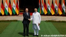 German Chancellor Olaf Scholz shakes hands with Indian Prime Minister Narendra Modi before their meeting at the Hyderabad House in New Delhi, India, February 25, 2023. REUTERS/Adnan Abidi
