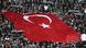 A huge Turkish flag unfurled over Besiktas supporters in a stadium A huge Turkish flag unfurled over Besiktas supporters in a stadium