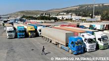 FILE PHOTO: Trucks carrying aid from UN World Food Programme (WFP), following a deadly earthquake, are parked at Bab al-Hawa crossing, Syria February 20, 2023. REUTERS/Mahmoud Hassano/File Photo