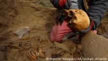 LIMA, PERU - OCTOBER 3: Archaeologists work at an 800-year-old pre-Hispanic burial site in the Carabayllo district of Lima, Peru on October 3, 2022. A team of workers from the Calidda gas company that was excavating to lay gas pipes found human remains that were wrapped in brown cloth tied with ropes and would belong to inhabitants of the Chancay and Huaura cultures. In addition, the tombs found had ceramic vessels next to them. So far we have found eleven burials of adults and children who were buried in the form of funerary bundles, said archaeologist Cecilia Camargo in charge of protecting the find. Klebher Vasquez / Anadolu Agency