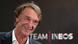 Ein lachender Jim Ratcliffe vor dem Logo von Team Ineos Ein lachender Jim Ratcliffe vor dem Logo von Team Ineos