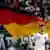 Thomas Müller jubelt über einen seiner beiden Treffer, im Hintergrund eine Deutschland-Fahne. Foto: dapd