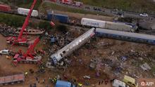 This aerial drone photograph taken on March 1, 2023, shows emergency crews examining the wreckage after a train accident in the Tempi Valley near Larissa, Greece. - At least 32 people were killed and another 85 injured after a collision between two trains caused a derailment near the Greek city of Larissa late at night on February 28, 2023, authorities said. A fire services spokesman confirmed that three carriages skipped the tracks just before midnight after the trains -- one for freight and the other carrying 350 passengers –- collided about halfway along the route between Athens and Thessaloniki. (Photo by STRINGER / AFP)