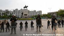 Feb. 1, 2023***
Riot police stand guard at plaza San Martin while anti-government protesters march against President Dina Boluarte in Lima, Peru, Wednesday, Feb. 1, 2023. Peru is facing a political crisis, with month-long protests that began after then-President Pedro Castillo was impeached and later arrested for trying to dissolve Congress on Dec. 7. Dina Boluarte, who was then vice president, took over. (AP Photo/Martin Mejia)