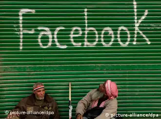epa02567628 Egyptian protesters sit outside a window shop with the word 'facebook' marked on it as demonstrators are still gathered in a protest called 'Sunday of the martyrs', Tahrir Square, Cairo, Egypt, 06 February 2011. Anti-government protests entered its 13th straight day in Egypt, as solutions were being mulled to bring about a power shift to end the country's political paralysis. Thousands of protesters slept in Cairo's central Tahrir Square, camping out in tents and defying a curfew, while many others streamed to the area in the morning, refusing to relent on their core demand that President Hosni Mubarak step down. EPA/FELIPE TRUEBA