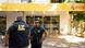 Police stand outside a supermarket owned by Lionel Messi's in-laws and shot up by gunmen Thursday Police stand outside a supermarket owned by Lionel Messi's in-laws and shot up by gunmen Thursday