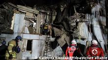 02.03.2023, Ukraine, Zaporizhzhia: Feuerwehrleute des ukrainischen Katastrophenschutzes inspizieren ein beschädigtes Haus nach einem russischen Raketenangriff. Die Rakete habe in der Nacht zum 02.03.2023 ein fünfstöckiges Wohnhaus getroffen, das dann eingestürzt sei, teilte der Sekretär des Stadtrats, Kurtjew, auf seinem Telegram-Kanal mit. Foto: Kateryna Klochko/AP +++ dpa-Bildfunk +++