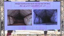 TOPSHOT - This frame grab taken from AFPTV shows people watching a video about a hidden passage inside the Great Pyramid of Khufu (Cheops) at the Giza Pyramids necropolis on the southwestern outskirts of Cairo on March 2, 2023. - Scientists have discovered a hidden passage inside Egypt's Great Pyramid, the authorities announced on March 2, part of a seven-year international research project. (Photo by Mohamed ABOUELENEN / various sources / AFP) (Photo by MOHAMED ABOUELENEN/AFPTV/AFP via Getty Images)