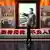 A man walks past a photo of Chinese President Xi Jinping at the Museum of the Communist Party of China in Beijing 