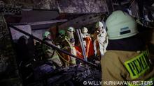 Firefighters carry a body bag of a victim after a fire broke out at a fuel storage station operated by Indonesia's state energy company Pertamina, in Jakarta, Indonesia, March 3, 2023. REUTERS/Willy Kurniawan