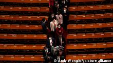 Delegates leave after the opening session of the Chinese People's Political Consultative Congress (CPPCC) at the Great Hall of the People in Beijing, Saturday, March 4, 2023. (AP Photo/Andy Wong)