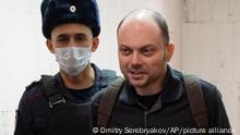 Russian opposition activist Vladimir Kara-Murza is escorted to a courtroom for hearing in a court in Moscow, Russia, Wednesday, Feb. 8, 2023. Kara-Murza was jailed in April 2022 on a charge of spreading false information about the Russian military. Russia adopted a law criminalizing spreading false information about its military shortly after Russian troops invaded Ukraine on Feb. 24, 2022. (AP Photo/Dmitry Serebryakov)