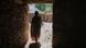 Woman walks out of a hut in rural Ethiopia Woman walks out of a hut in rural Ethiopia