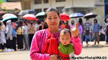 A woman voter and her baby in Nagaland 