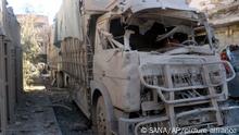08.03.2023**In this photo released by the Syrian official news agency SANA, shows a truck damaged after an explosion hit a building, in Deir el-Zour, Syria, Wednesday, March 8, 2023. An explosion in eastern Syria killed people, according to reports. A war monitoring group said the blast was likely caused by a drone strike that targeted Iran-backed militiamen.(SANA via AP)