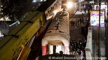 TOPSHOT - A crane is deployed to lift a derailed train at the scene of a railroad accident in the city of Qalyub in Qalyub province, in Egypt's Nile delta region north of the capital on March 7, 2023. (Photo by Khaled DESOUKI / AFP) (Photo by KHALED DESOUKI/AFP via Getty Images)