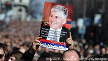 A demonstrator holds on March 12, 2013 a portrait of slain Prime Minister Zoran Djindjic during a silent march in Belgrade attended by more than 15,000 people to mark the 10th anniversary of his murder. Djindjic, the first democratically elected Prime Minister in post-communist Serbia was shot and killed by a single sniper in broad daylight on March 12, 2003, at the doorstep of a Serbian government building. AFP PHOTO / ANDREJ ISAKOVIC (Photo credit should read ANDREJ ISAKOVIC/AFP via Getty Images)