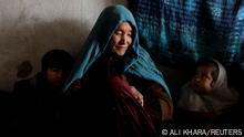 Sakineh, who lost a grandchild at birth, sits with her grandchildren inside her house in Foladi Valley in Bamiyan, Afghanistan, March 2, 2023. Aziza Rahimi, 35, Sakineh’s daughter-in-law, stumbled while bleeding for two hours to her in-laws' house after her husband was unable to find a car or ambulance to take them to hospital, she gave birth but the baby died shortly after. It was too hard for me when I lost my baby, as a mother I nurtured the baby in my womb for 9 months but then I lost him, it is too painful, she said. REUTERS/Ali Khara SEARCH KHARA MIDWIVES FOR THIS STORY. SEARCH WIDER IMAGE FOR ALL STORIES.