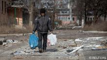 A local resident walks on an empty street, as Russia's attack on Ukraine continues, in the front line city of Bakhmut, Ukraine March 3, 2023. REUTERS/Oleksandr Ratushniak