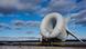 A giant flying turbine - a gray round structure with three blades