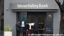 10/03/2023 People look at signs posted outside of an entrance to Silicon Valley Bank in Santa Clara, Calif., Friday, March 10, 2023. The Federal Deposit Insurance Corporation is seizing the assets of Silicon Valley Bank, marking the largest bank failure since Washington Mutual during the height of the 2008 financial crisis. The FDIC ordered the closure of Silicon Valley Bank and immediately took position of all deposits at the bank Friday. (AP Photo/Jeff Chiu)