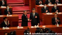 Newly elected Premier Li Qiang, center left, shakes hands with Chinese President Xi Jinping as former Premier Li Keqiang, at right, applauds during a session of China's National People's Congress (NPC) at the Great Hall of the People in Beijing, Saturday, March 11, 2023. (AP Photo/Mark Schiefelbein)